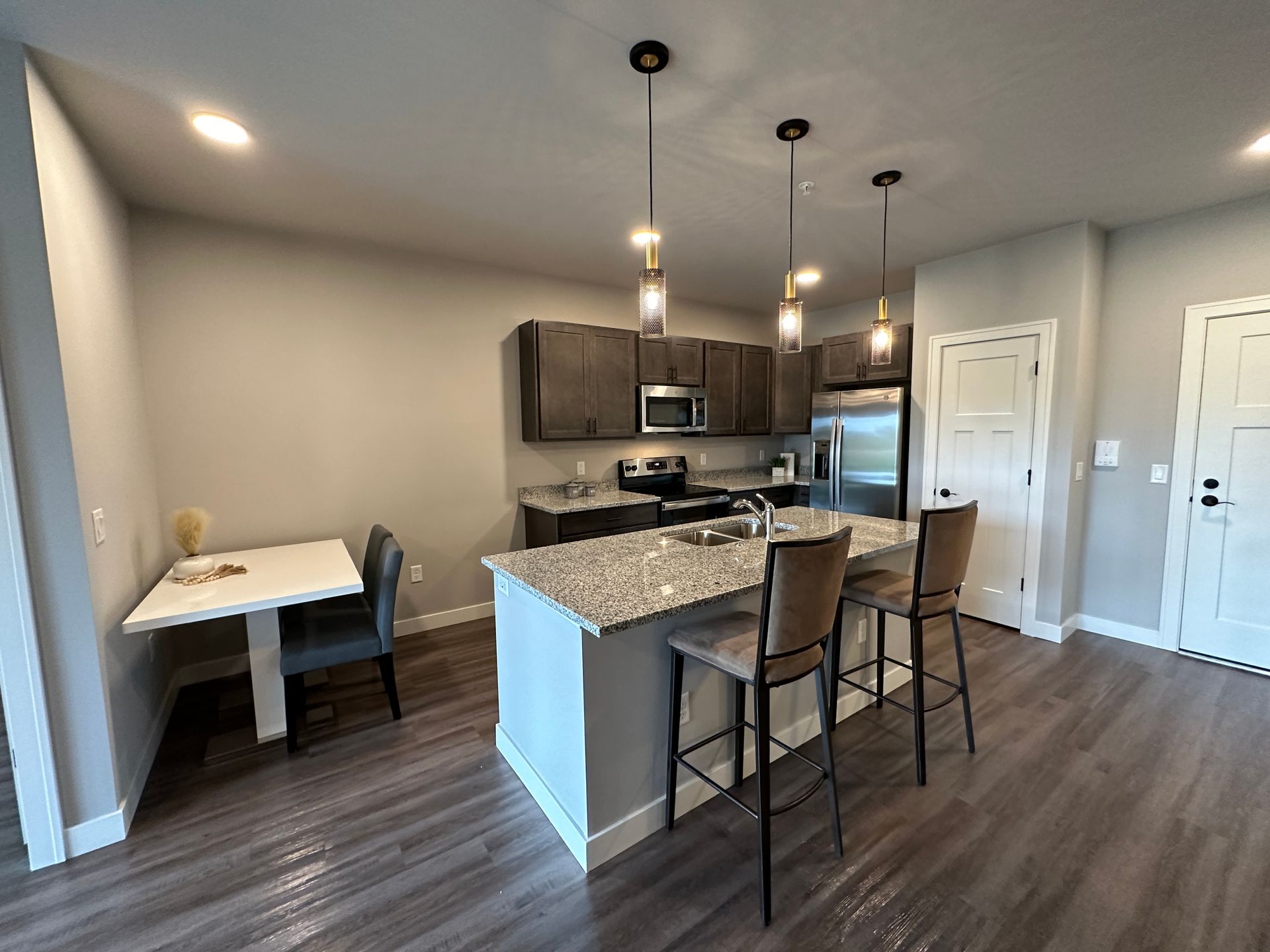 a kitchen with granite counter tops and stainless steel appliances