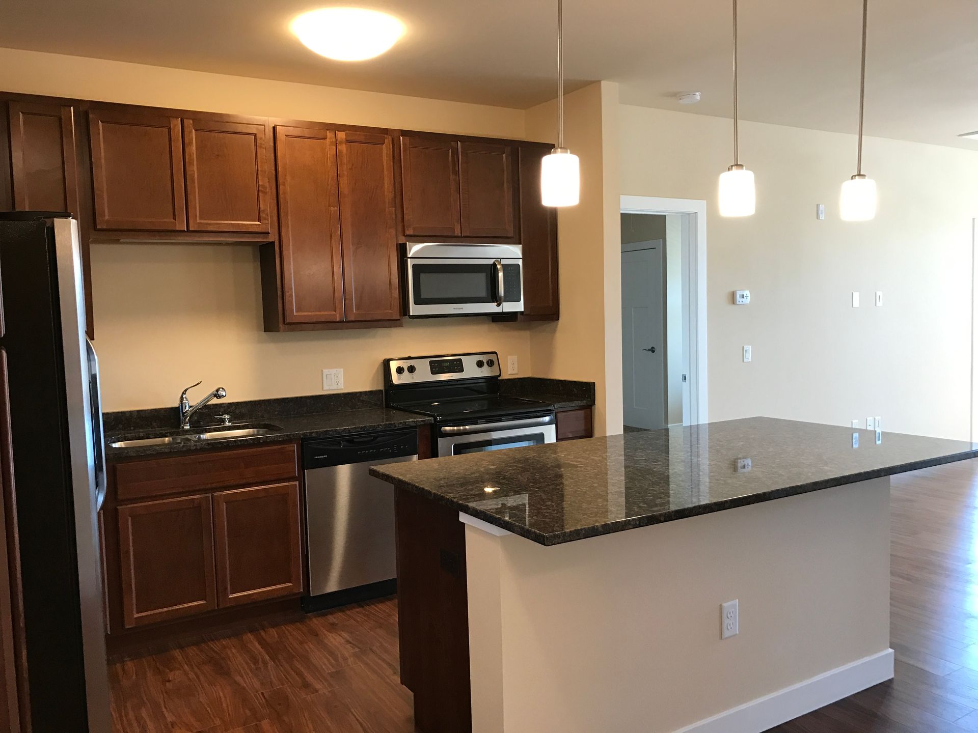 a kitchen with stainless steel appliances and granite counter tops