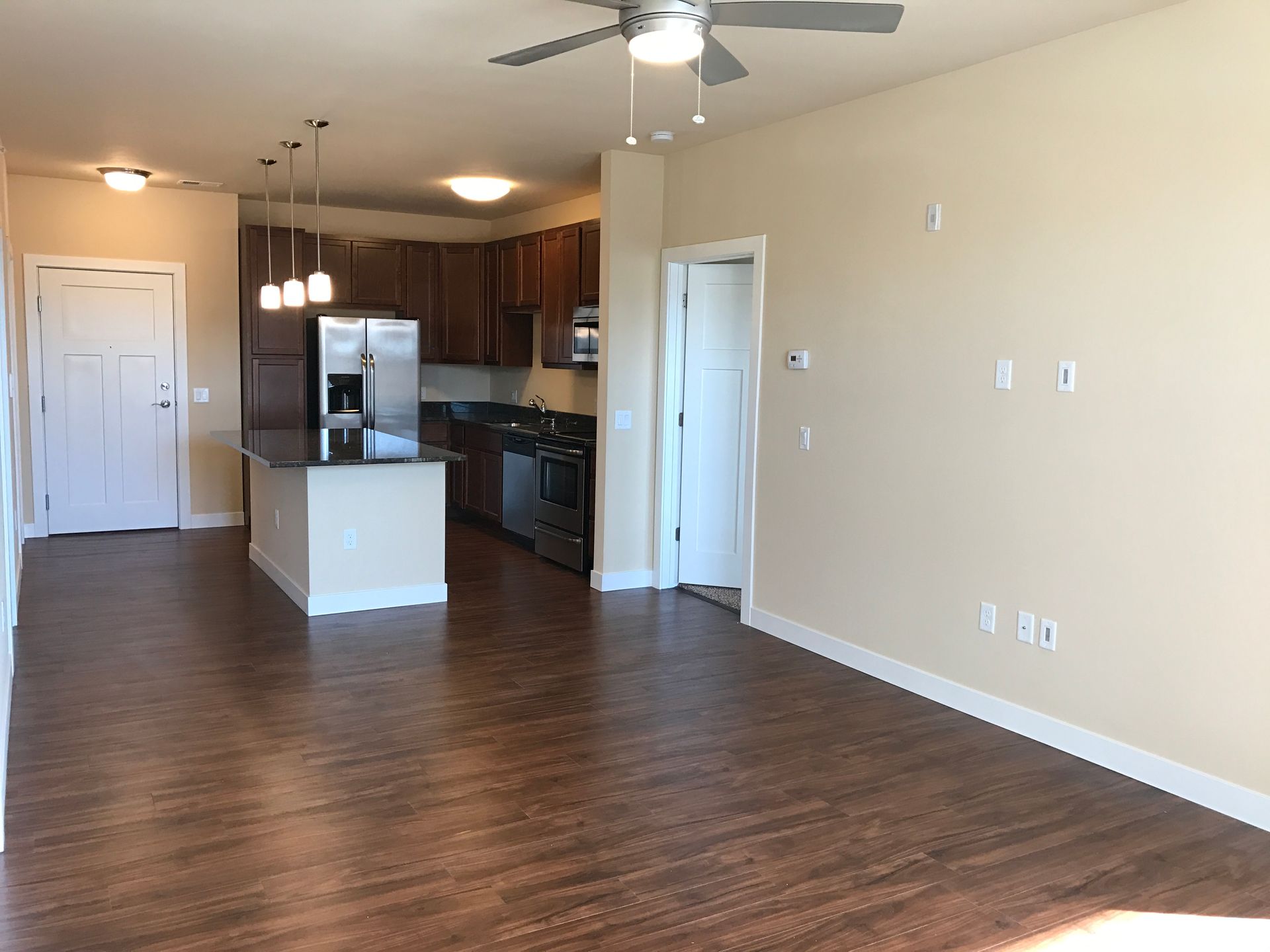 a kitchen with stainless steel appliances and a ceiling fan