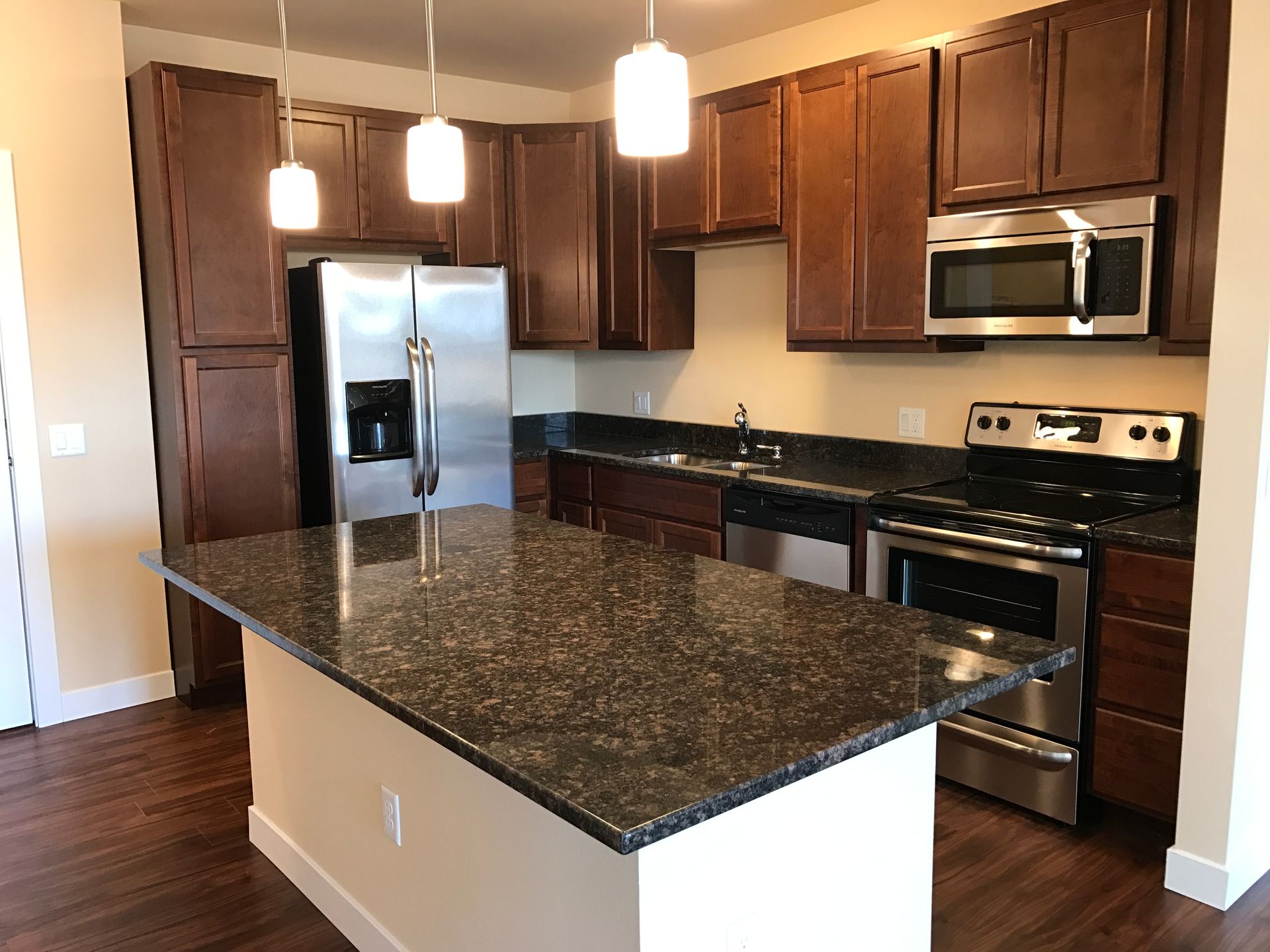 a kitchen with stainless steel appliances and granite counter tops