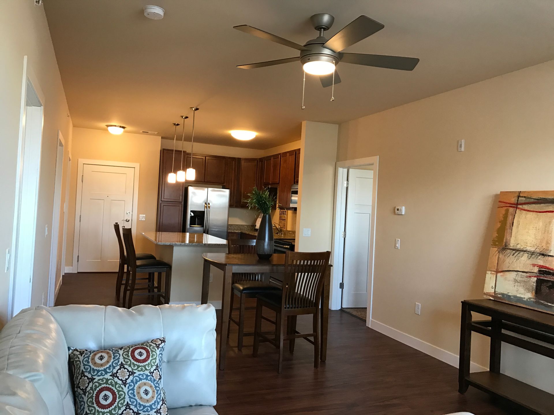 a living room with a couch and a ceiling fan