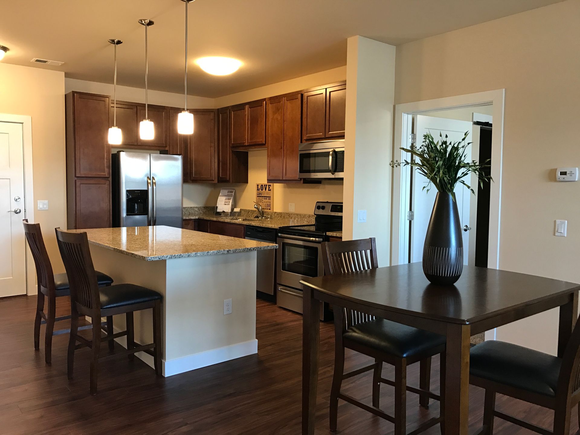 a kitchen with a sign that says love on it