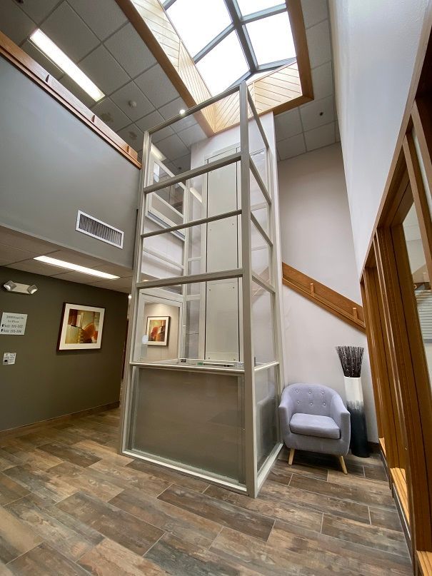 an elevator in a building with a chair in front of it