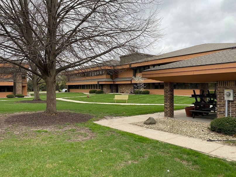 a large building with a picnic table in front of it .