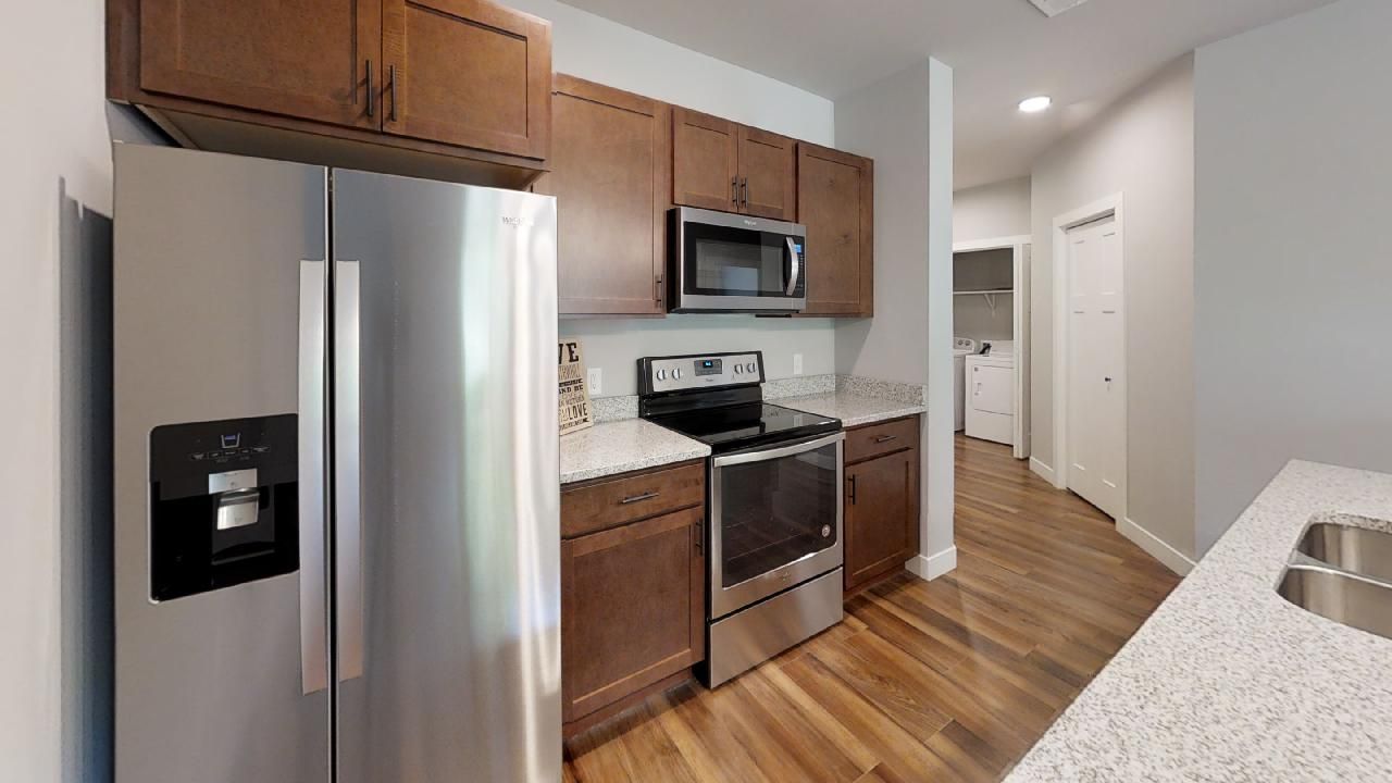 a kitchen with a stainless steel refrigerator and a microwave