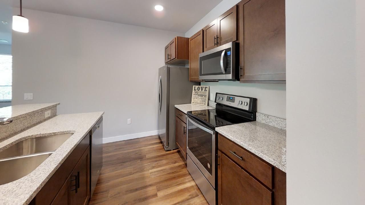 a kitchen with a sign that says love on it