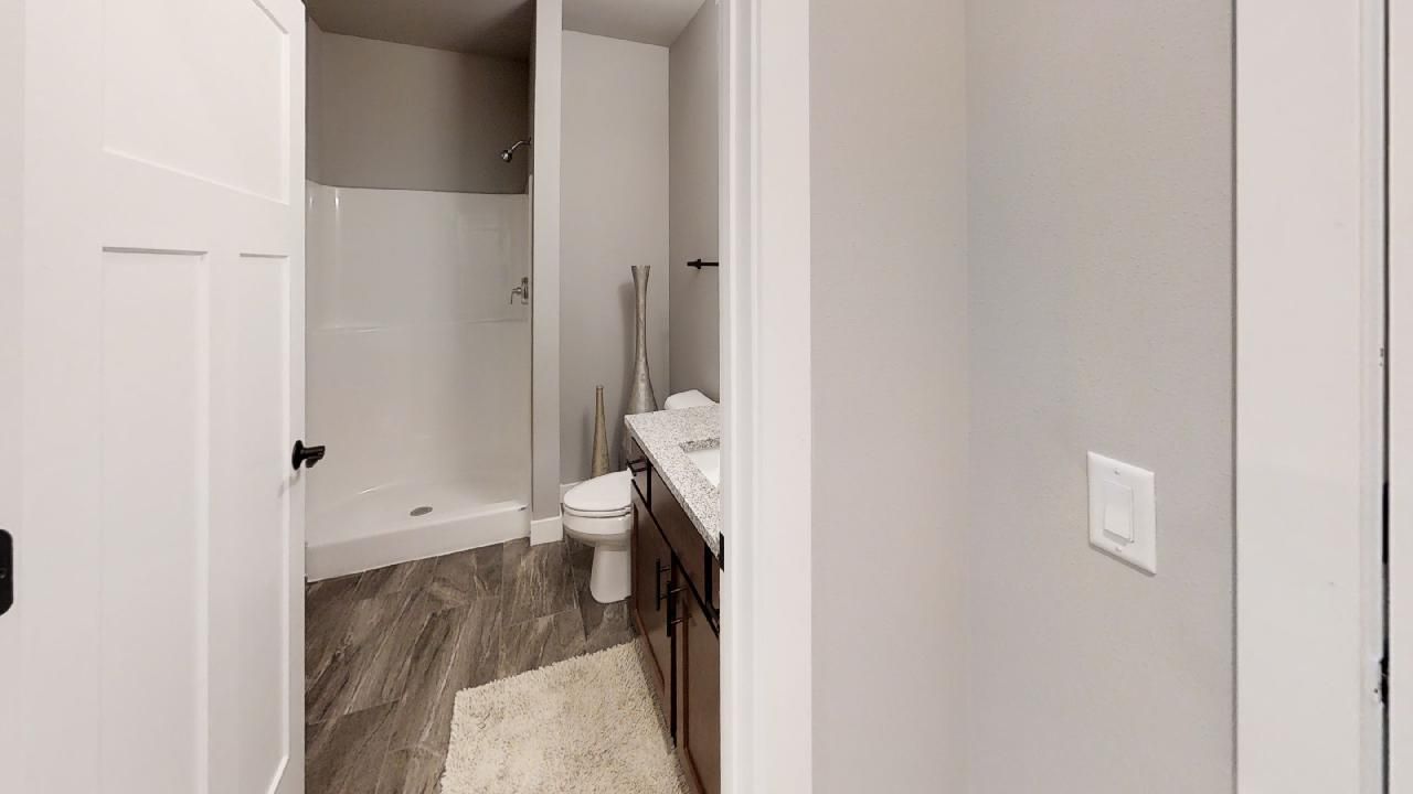 a bathroom with a toilet a sink and a shower