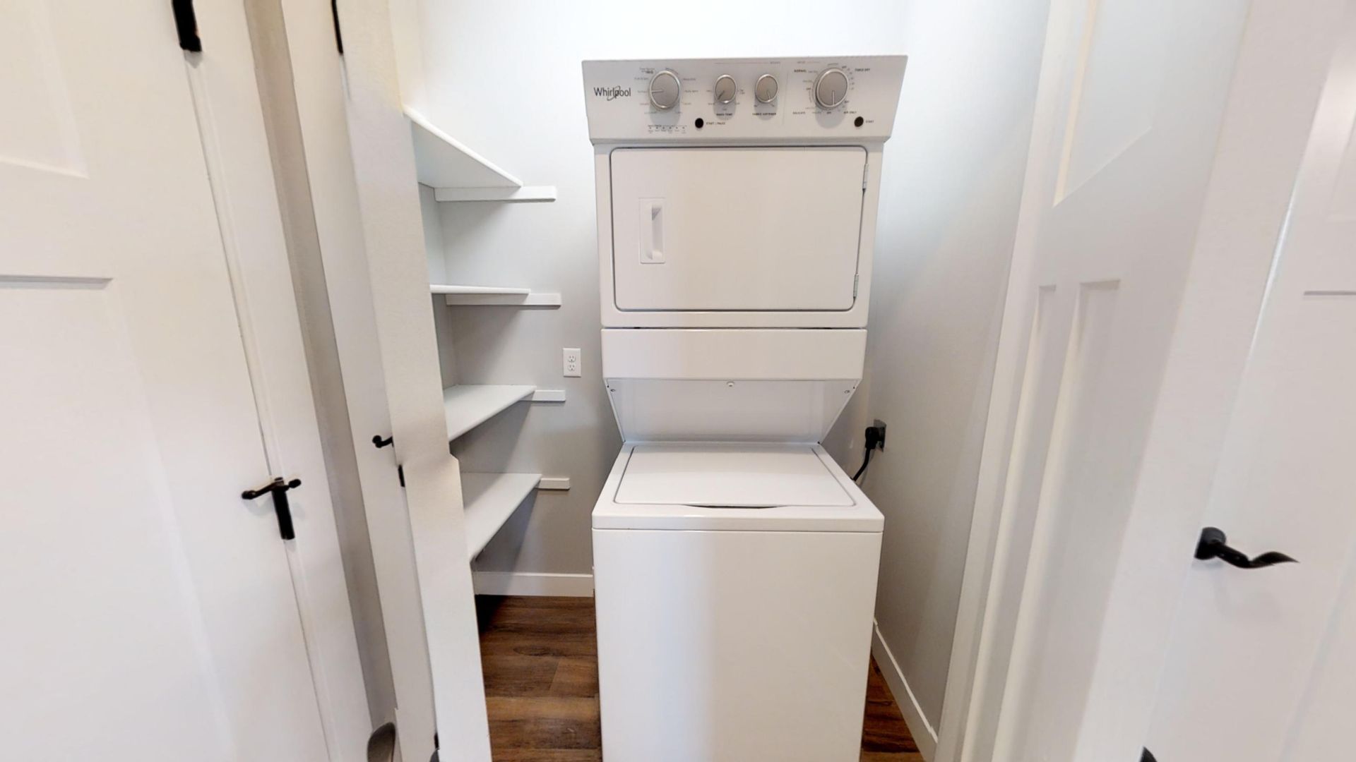 a white whirlpool washer and dryer stacked on top of each other