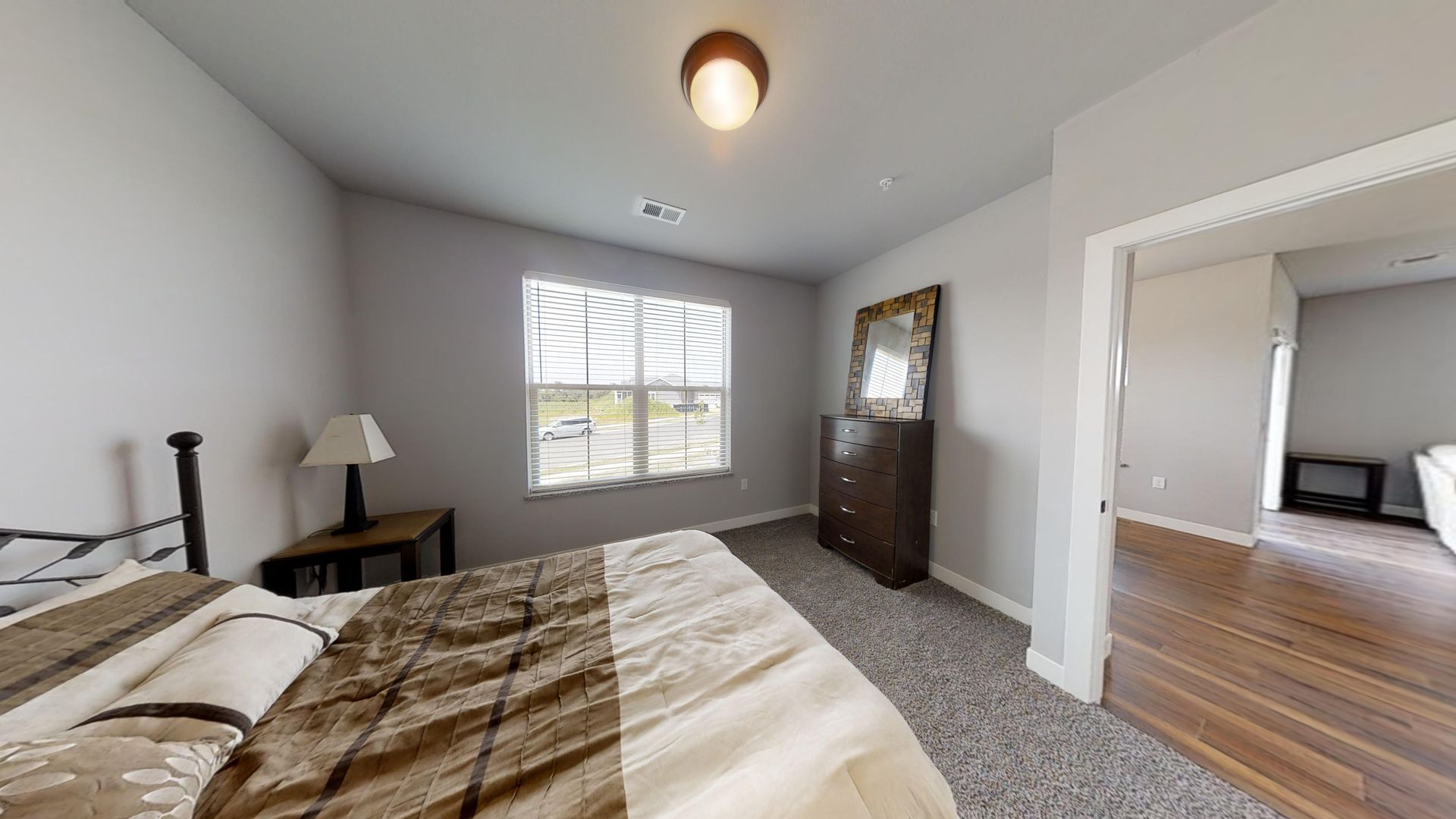 a bedroom with a large bed and a dresser