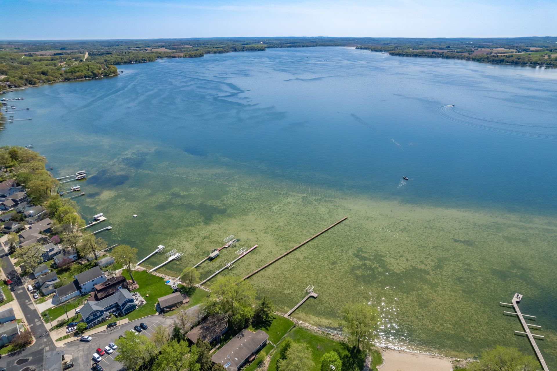 an aerial view of a lake with a lot of boats in it