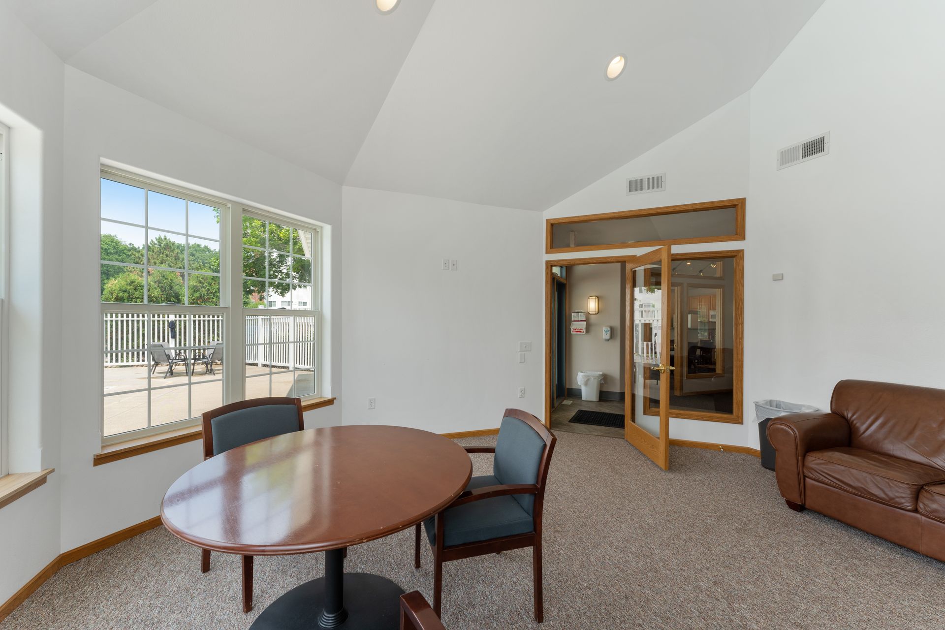 a room with a table and chairs and a couch