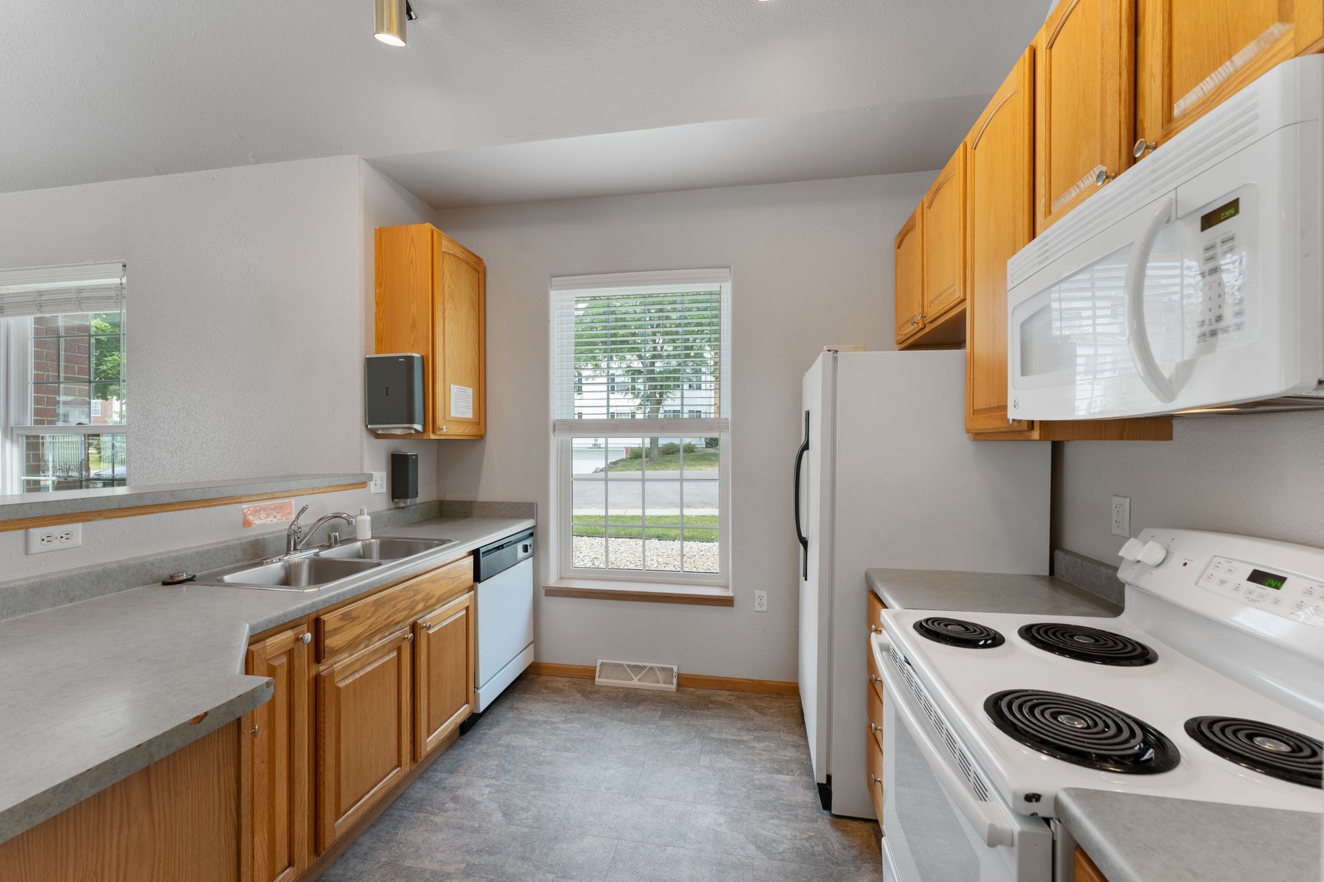 a kitchen with a stove top oven and a microwave