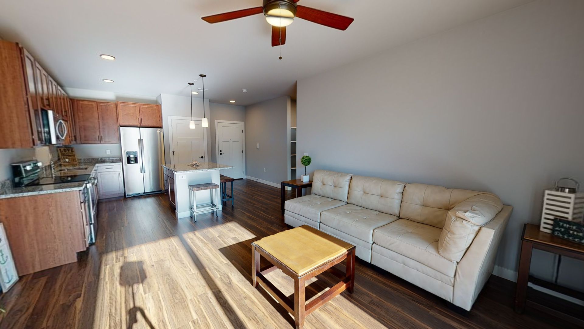 a living room with a couch and a ceiling fan