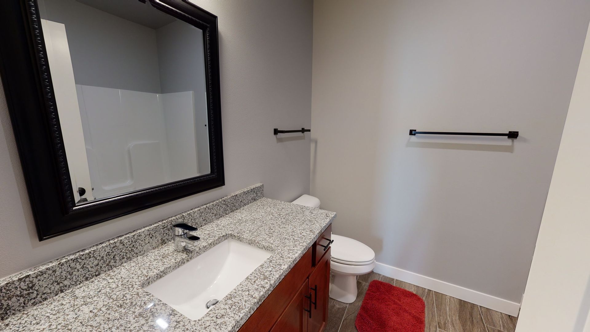 a bathroom with a sink toilet and mirror