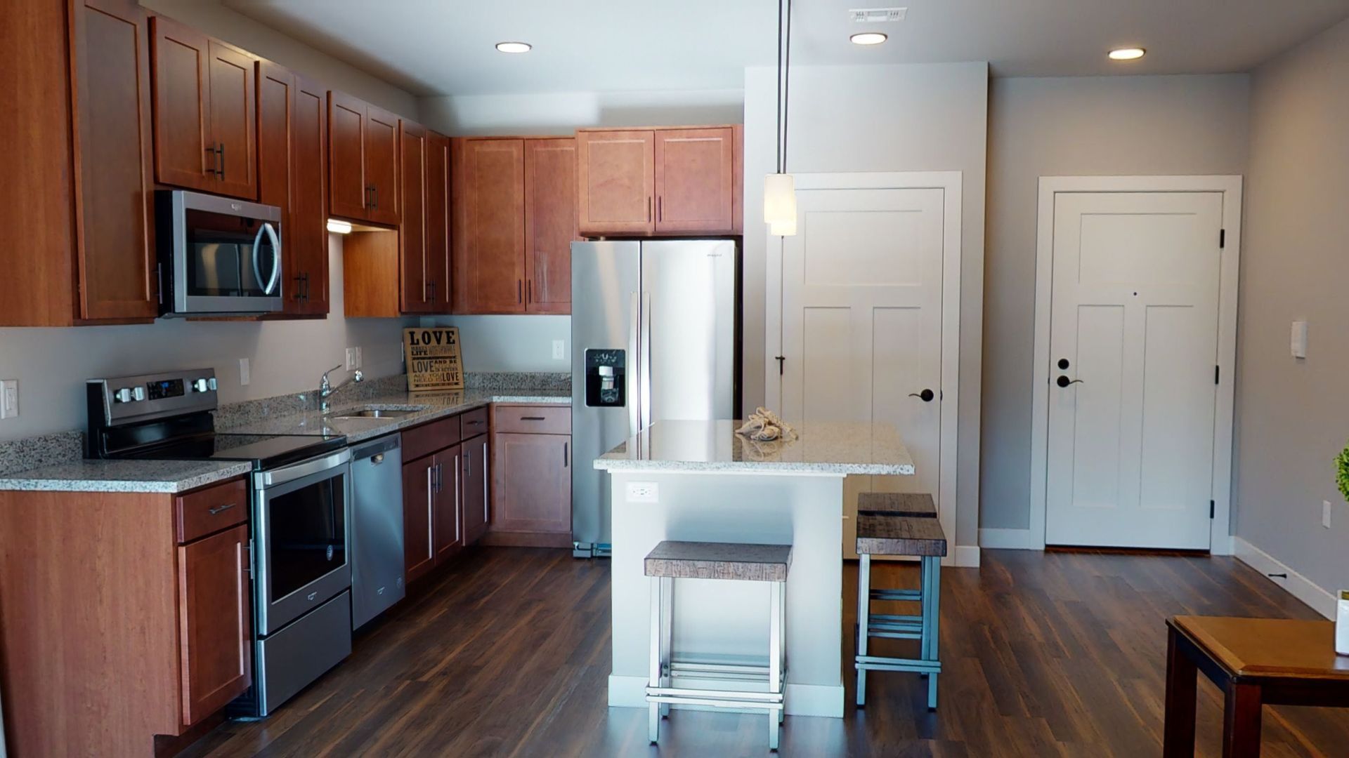 a kitchen with a sign that says love on it