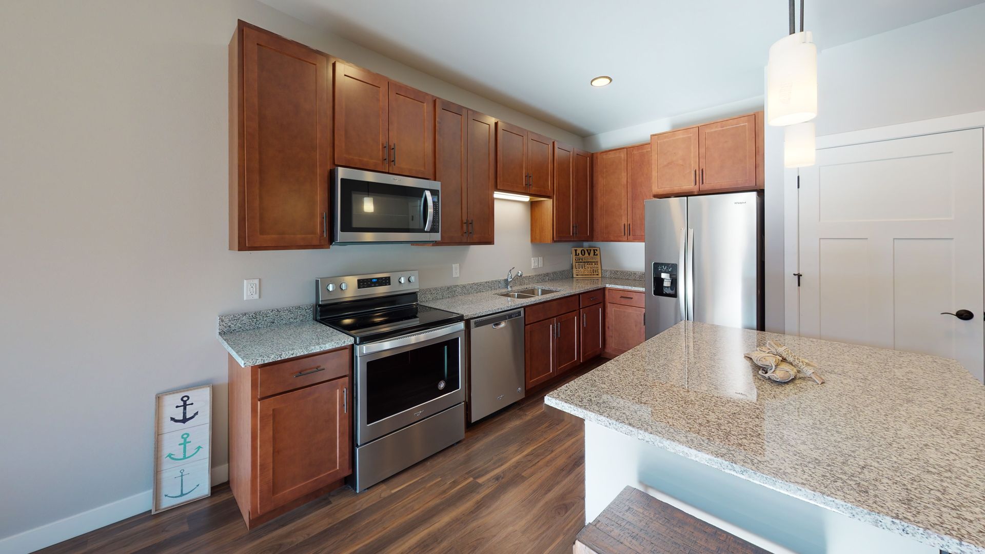 a kitchen with stainless steel appliances and granite counter tops