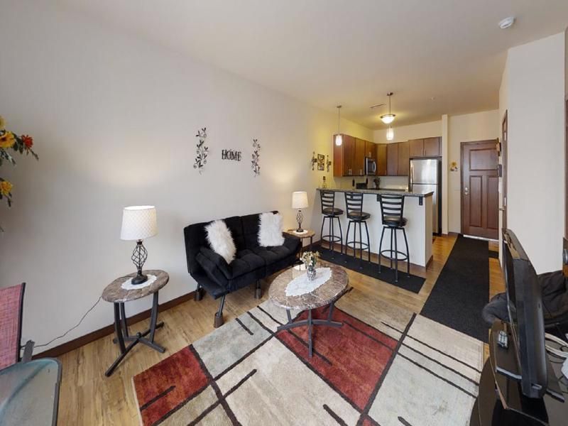 a living room with a sign on the wall that says home