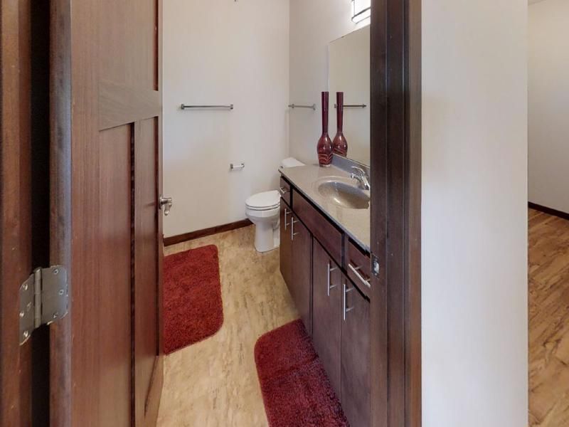 a bathroom with a toilet , sink and mirror