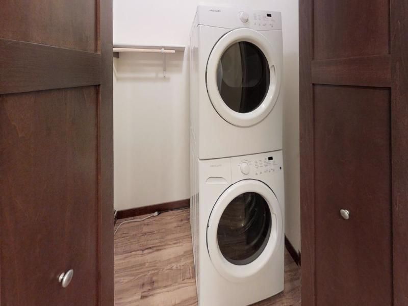 a white frigidaire washer and dryer stacked on top of each other