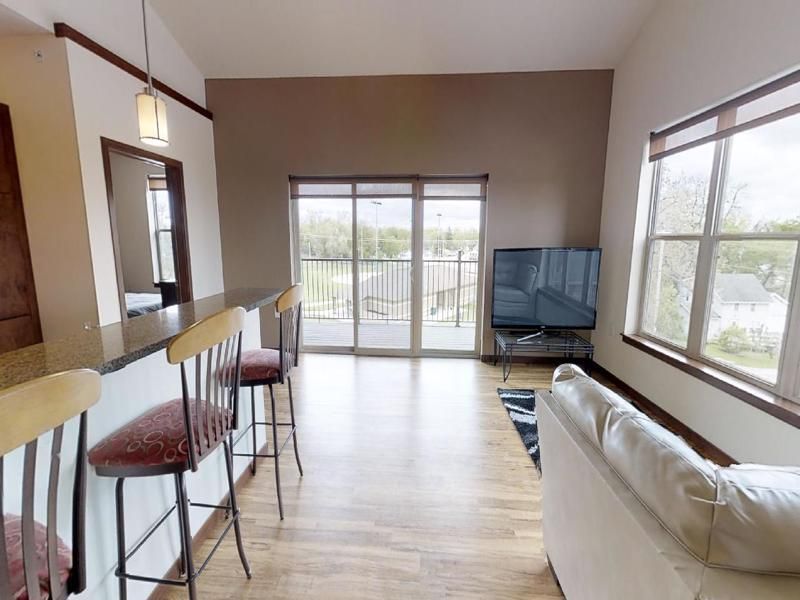 a living room with a white couch and a flat screen tv