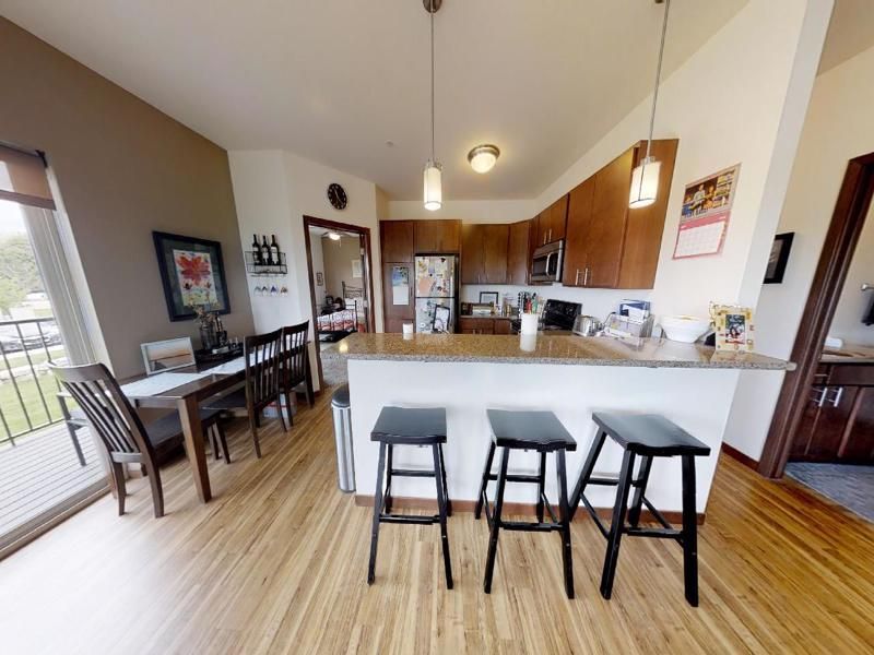 a kitchen with stools and a calendar on the wall