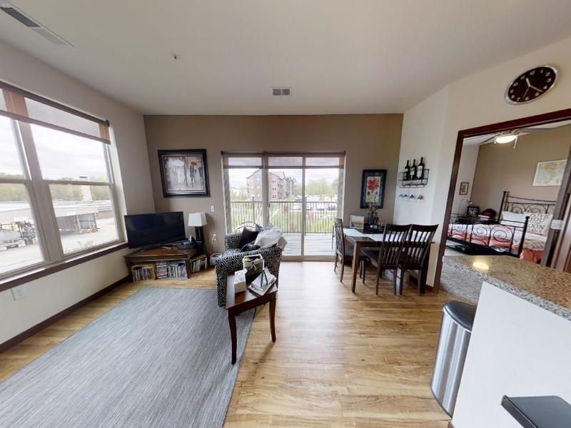 a living room with a sliding glass door leading to a balcony