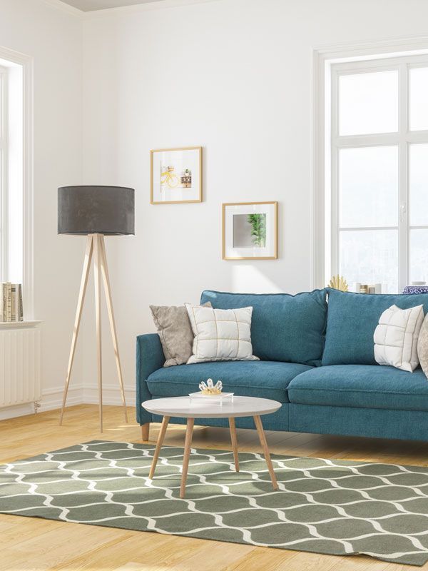 a living room with a blue couch and a rug