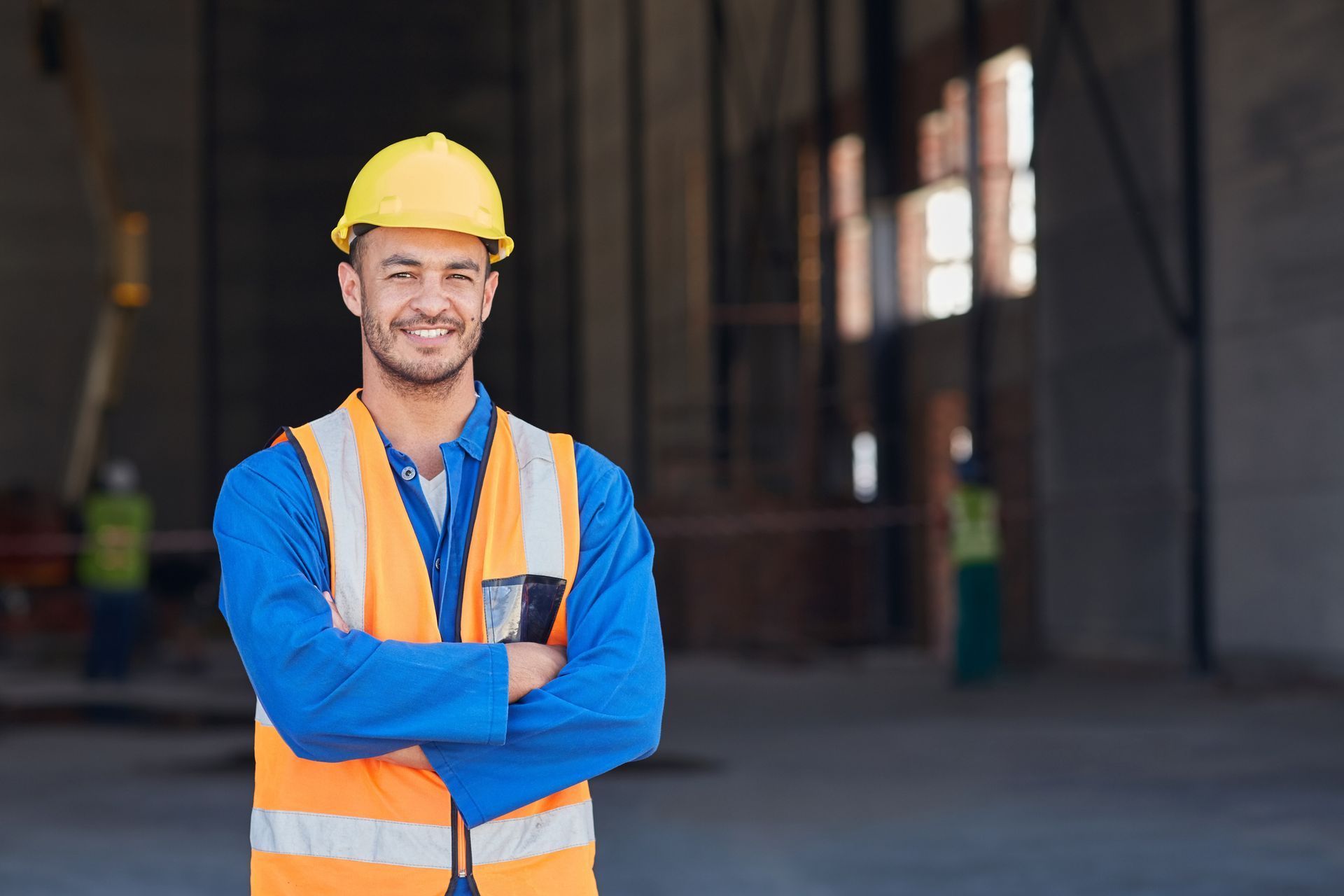 Person wearing a hard hat and vest.