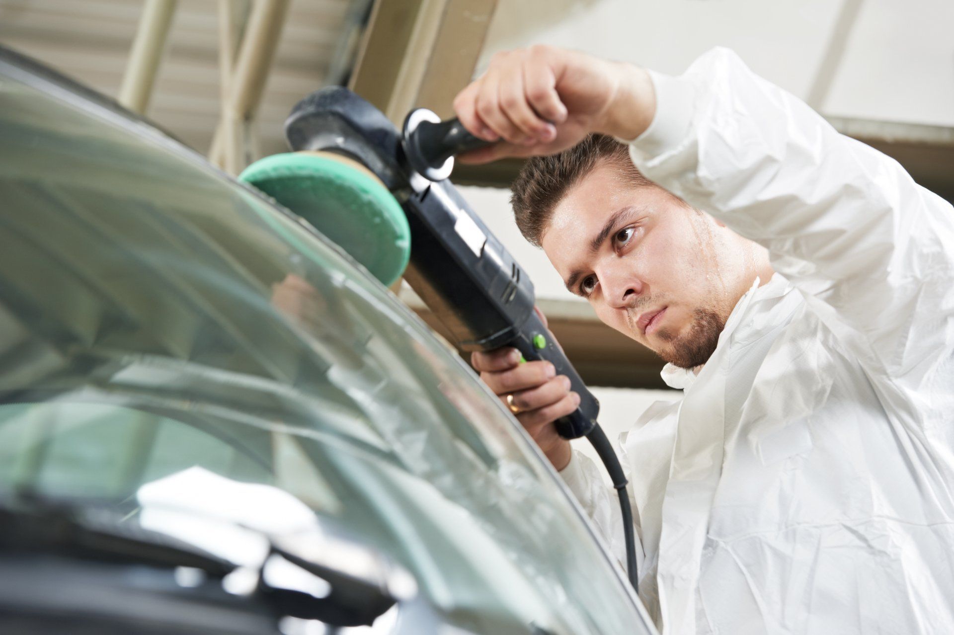 A man working on a stone chip repair in Butler, PA