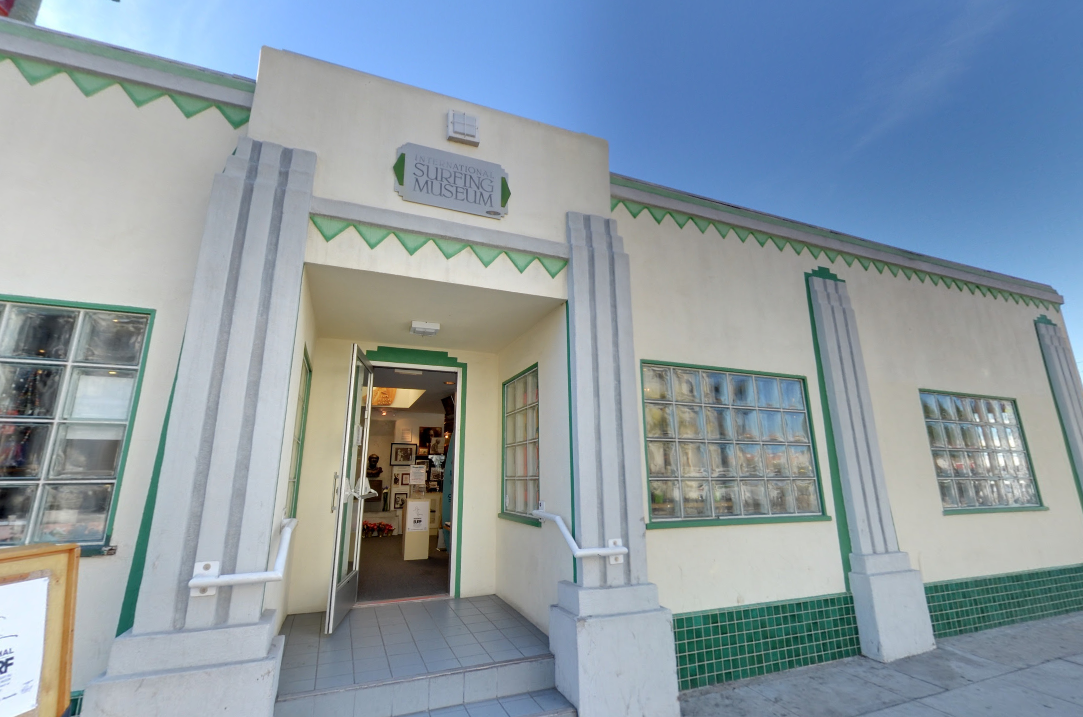 A white building with green trim and a sign that says cafe