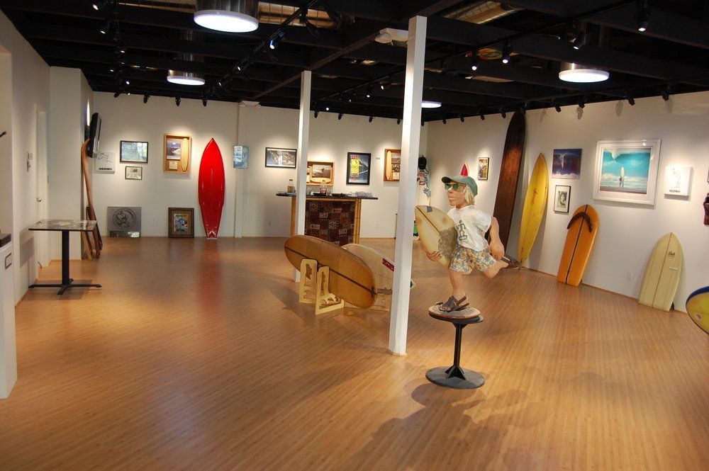 A room with a lot of surfboards on the wall