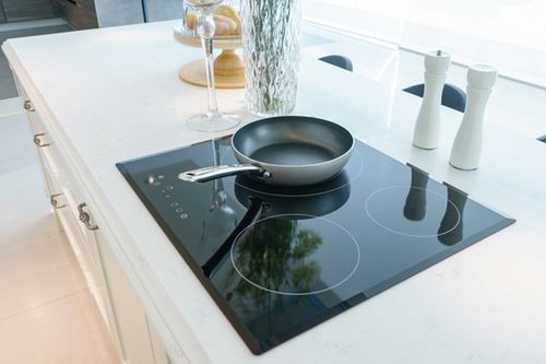 Frying Pan on Modern Black Induction Stove — Kansas City, MO — At Your Service Appliance Repair