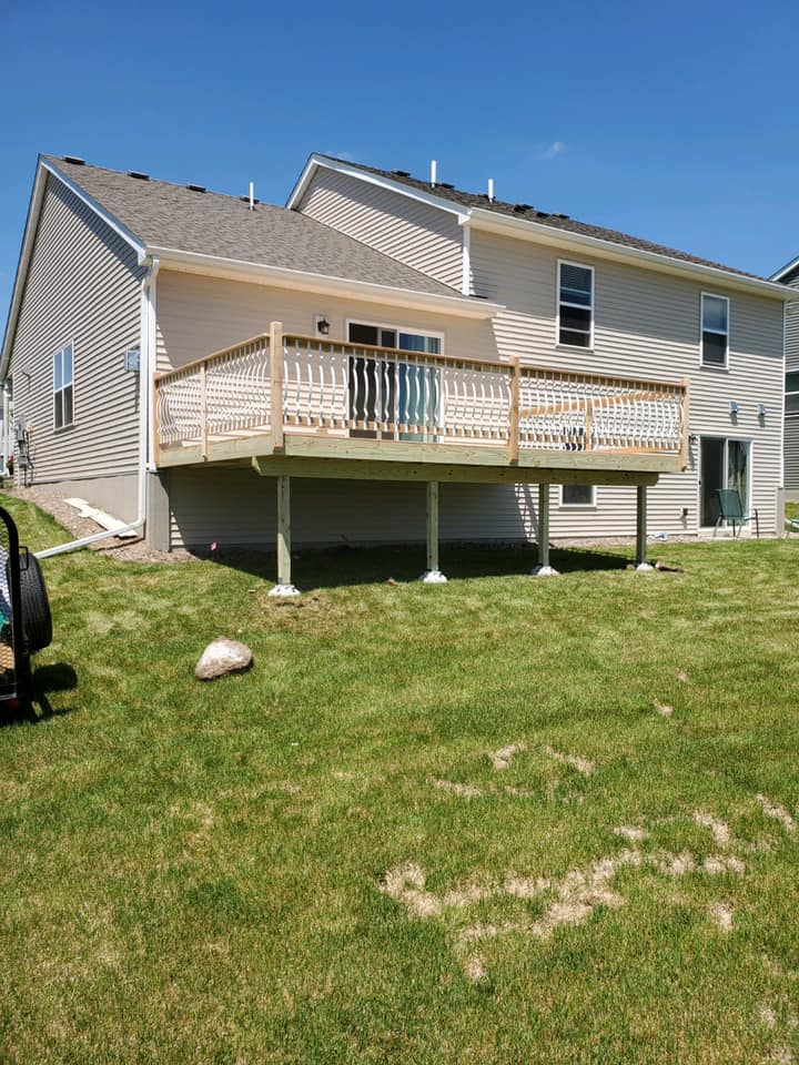 Finished wooden deck behind brown home  in Minot ND