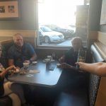 A group of people are sitting at a table in a restaurant.