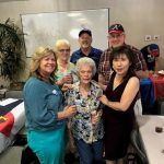 A group of people are posing for a picture in a room.