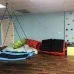 There is a swing in the middle of the room.