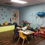 A room filled with tables and chairs and toys.