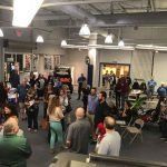 A large group of people are gathered in a large room.