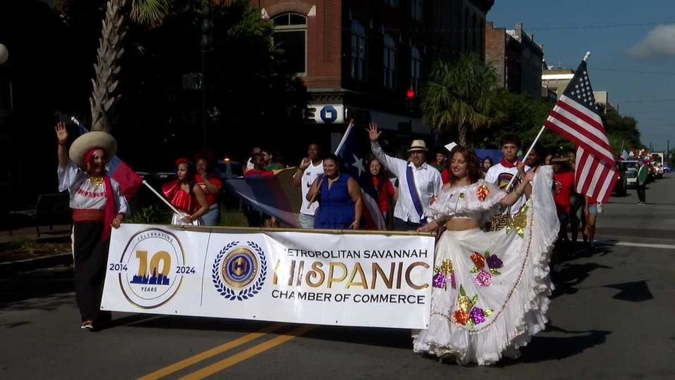 A parade with a banner that says hispanica on it