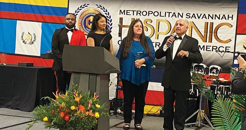 A group of people are standing at a podium giving a speech.