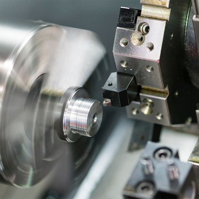 a machine is cutting a piece of metal on a lathe