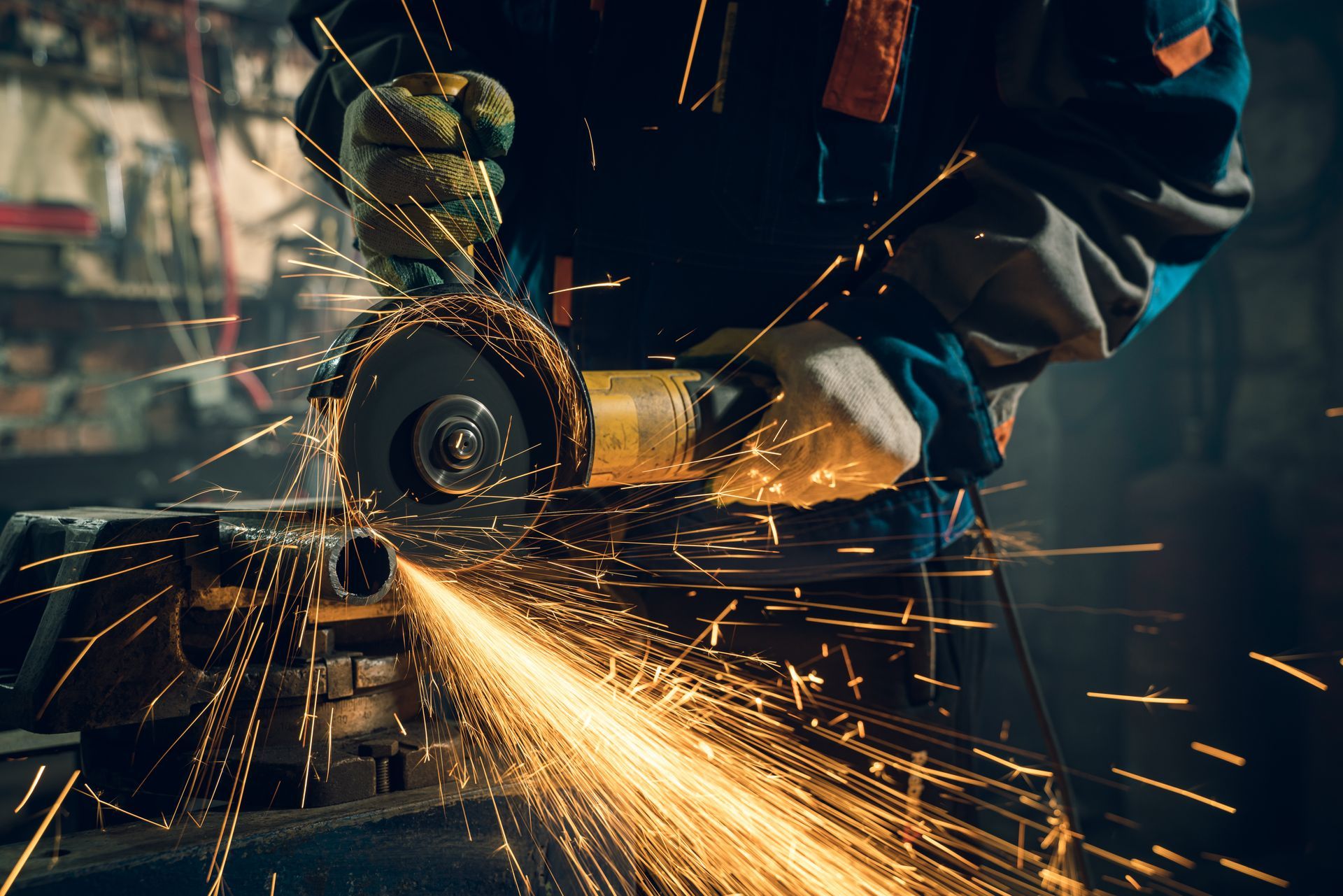 a man is using a grinder to cut a piece of metal