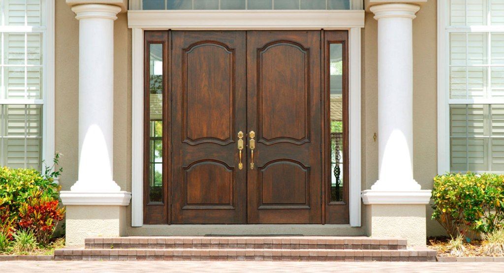 The front door of a house with two wooden doors