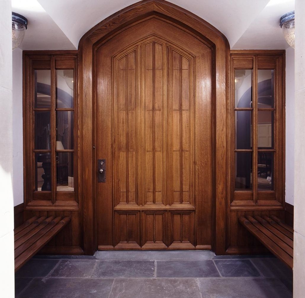 A wooden door in a room with two benches