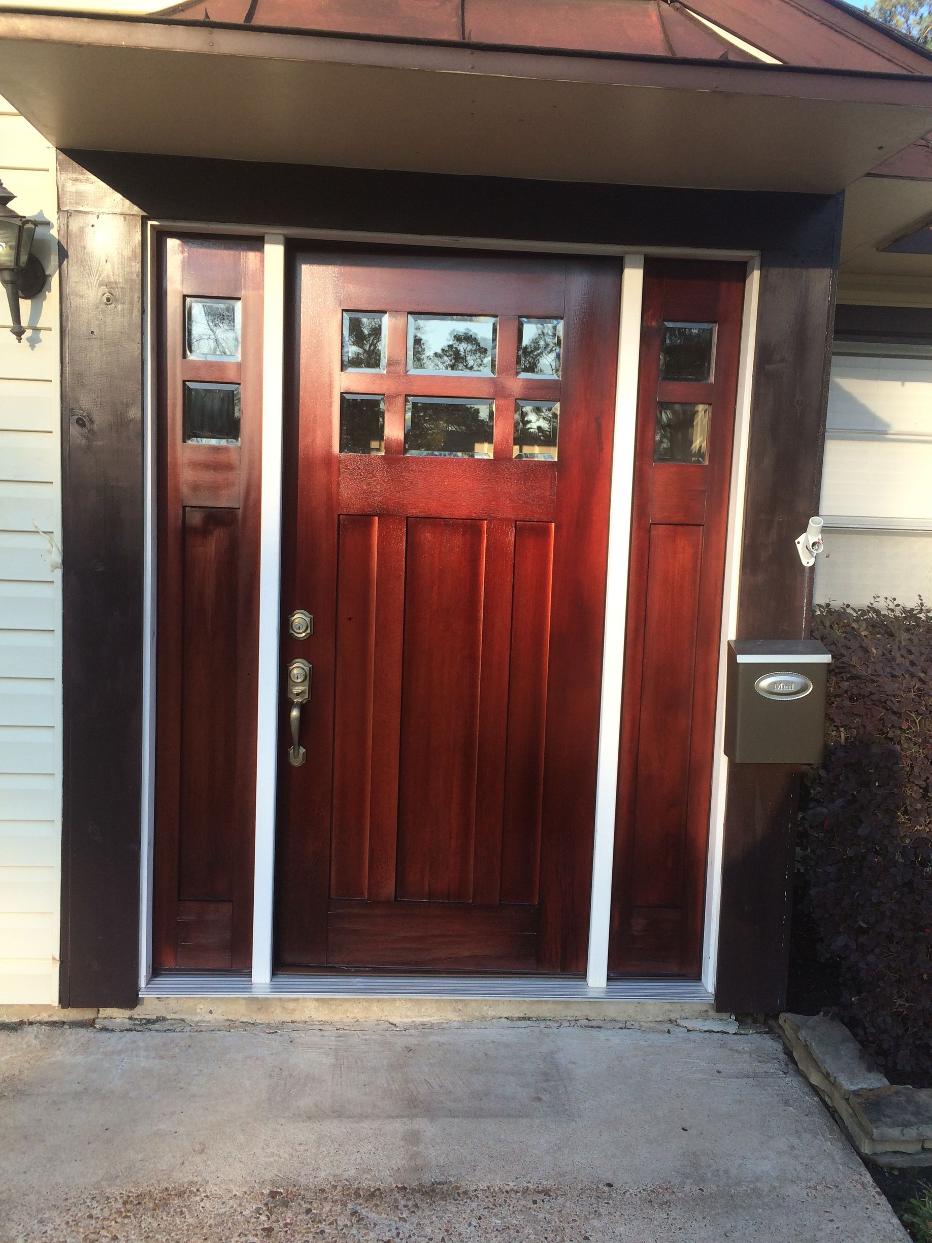 The front door of a house with a mailbox in front of it