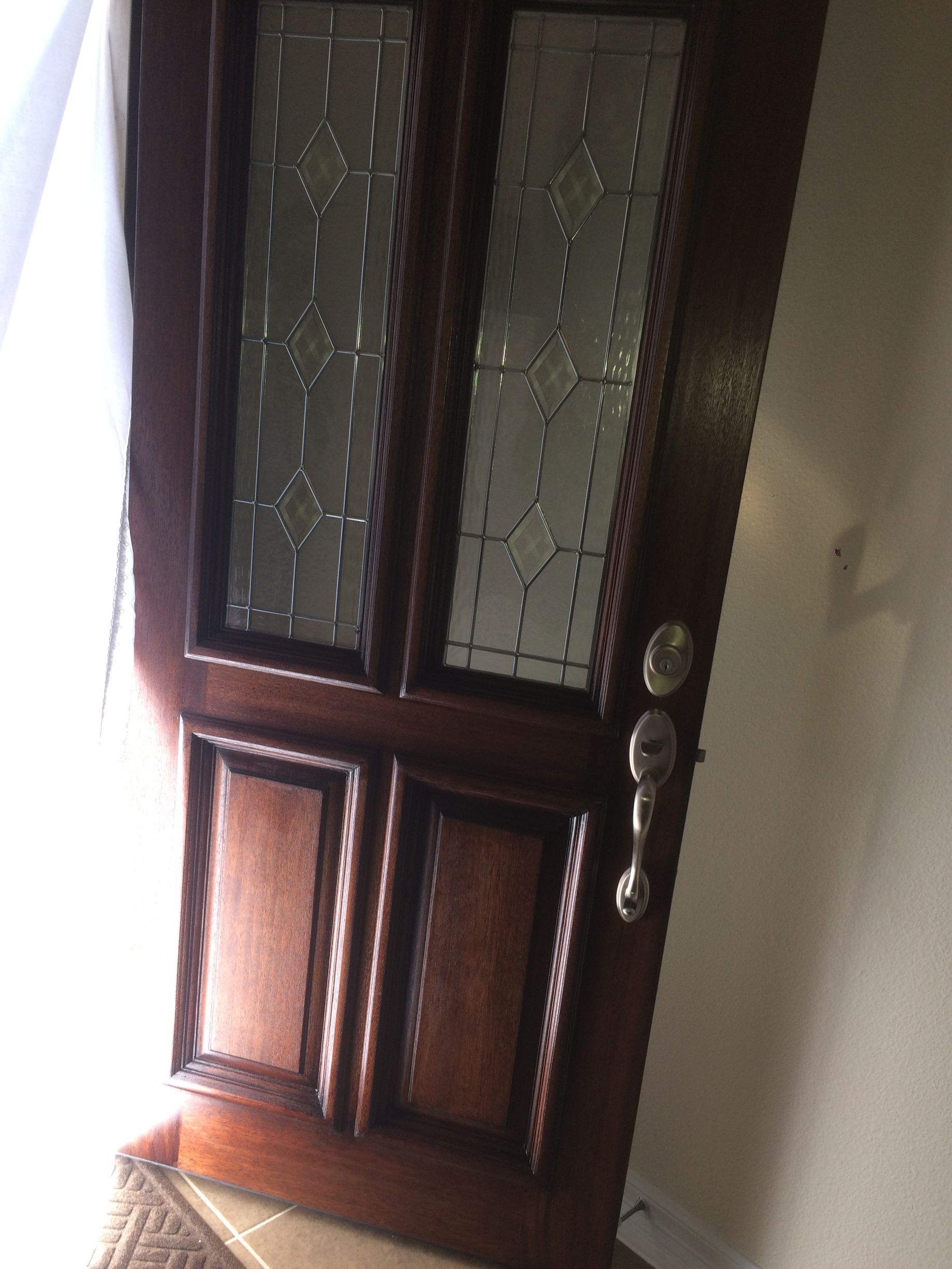 A wooden door with a stained glass window