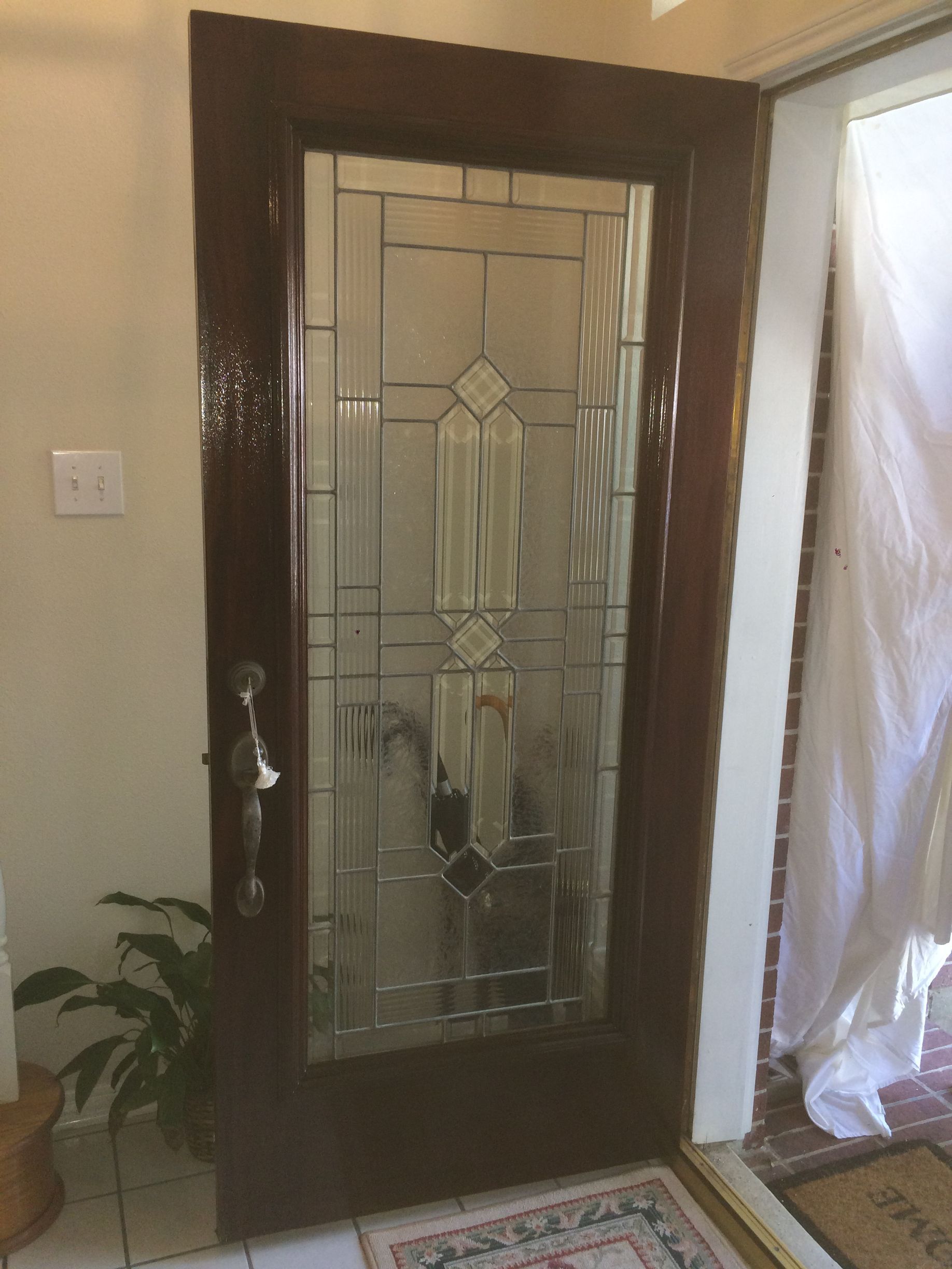 A door with a stained glass window in a hallway