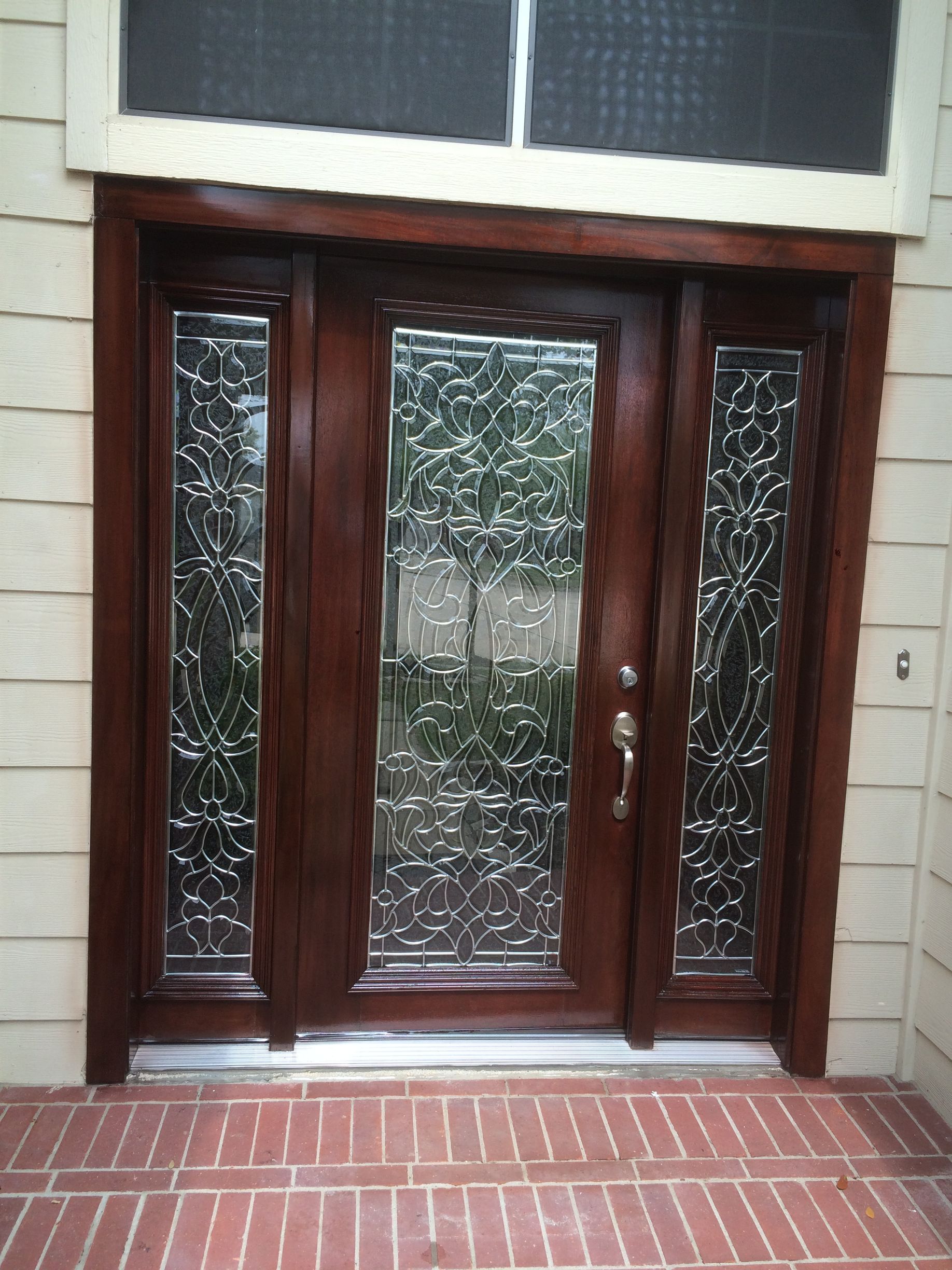 A wooden door with a stained glass window