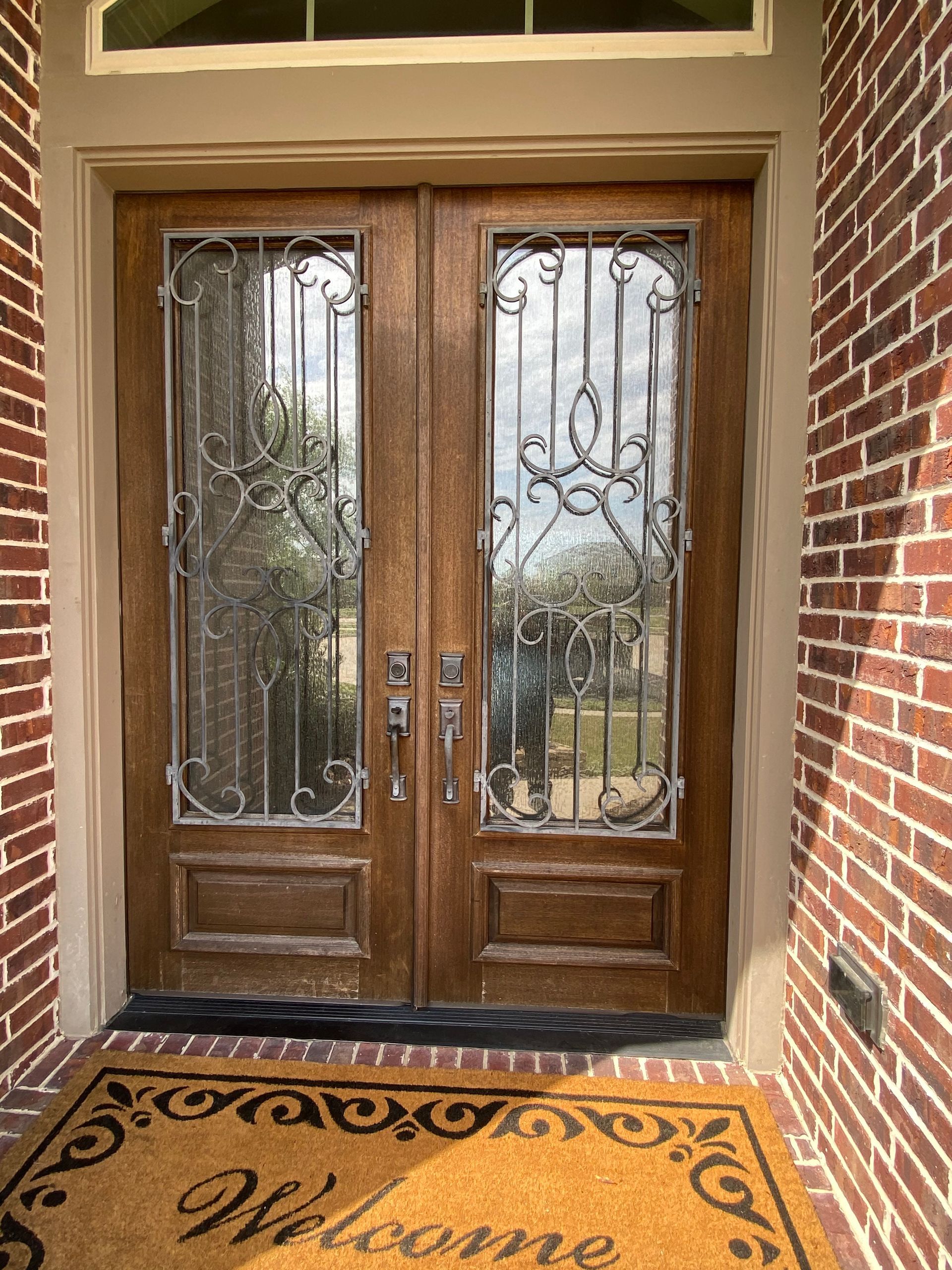 There is a welcome mat in front of the door.