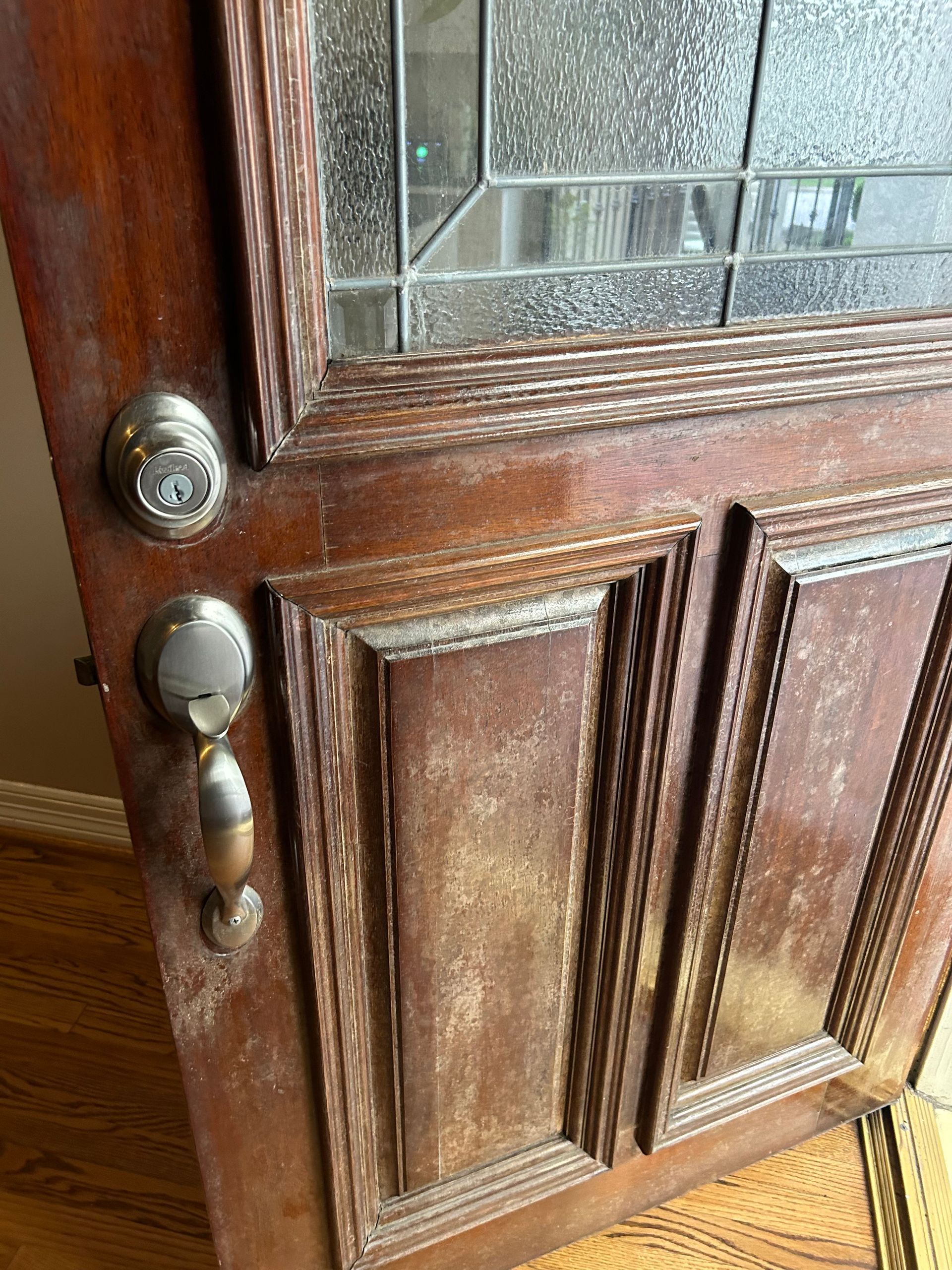 A person is opening a door with a door handle.